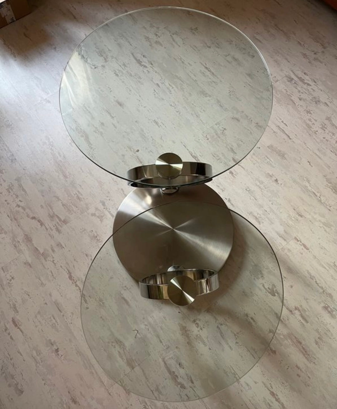 Pivoting glass and stainless steel coffee table