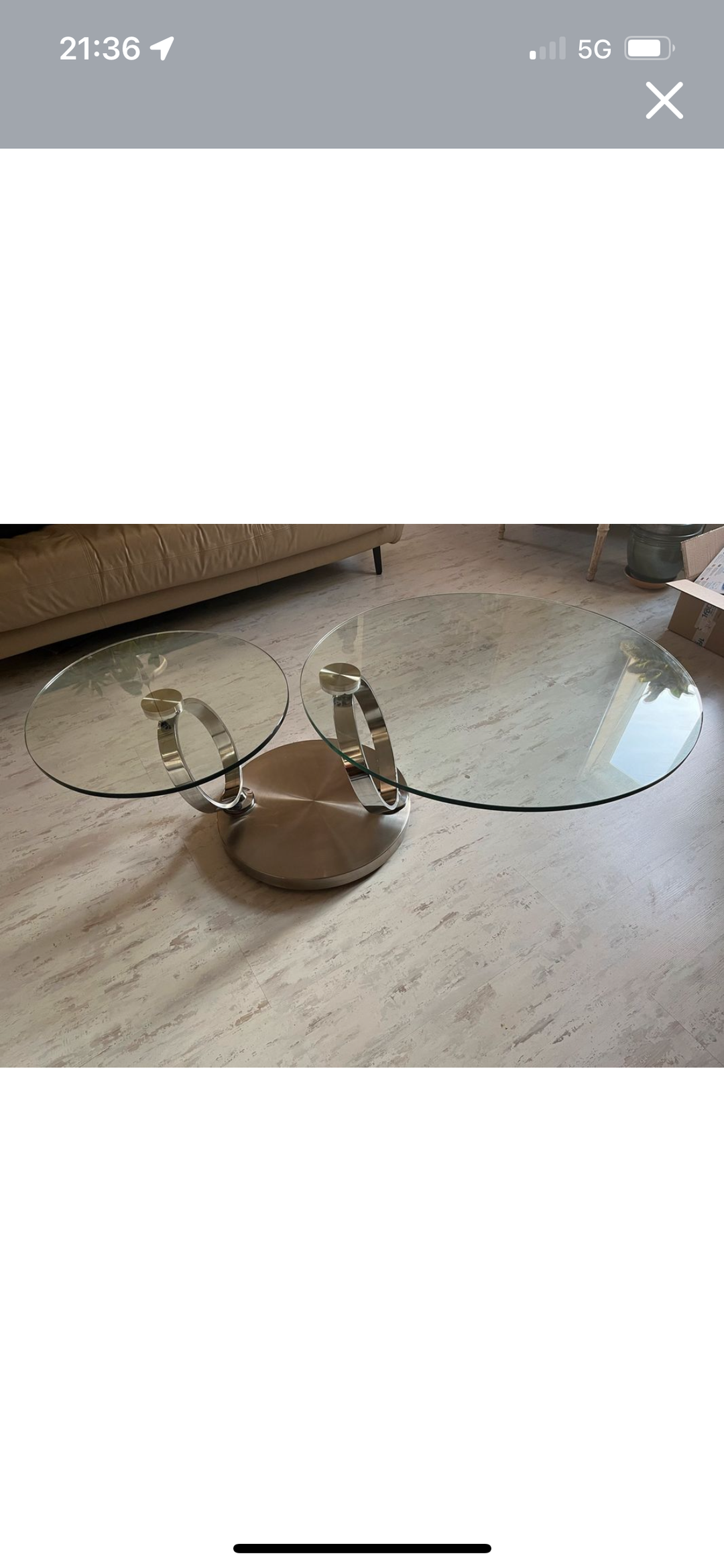 Pivoting glass and stainless steel coffee table