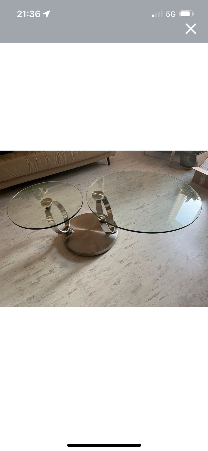 Pivoting glass and stainless steel coffee table