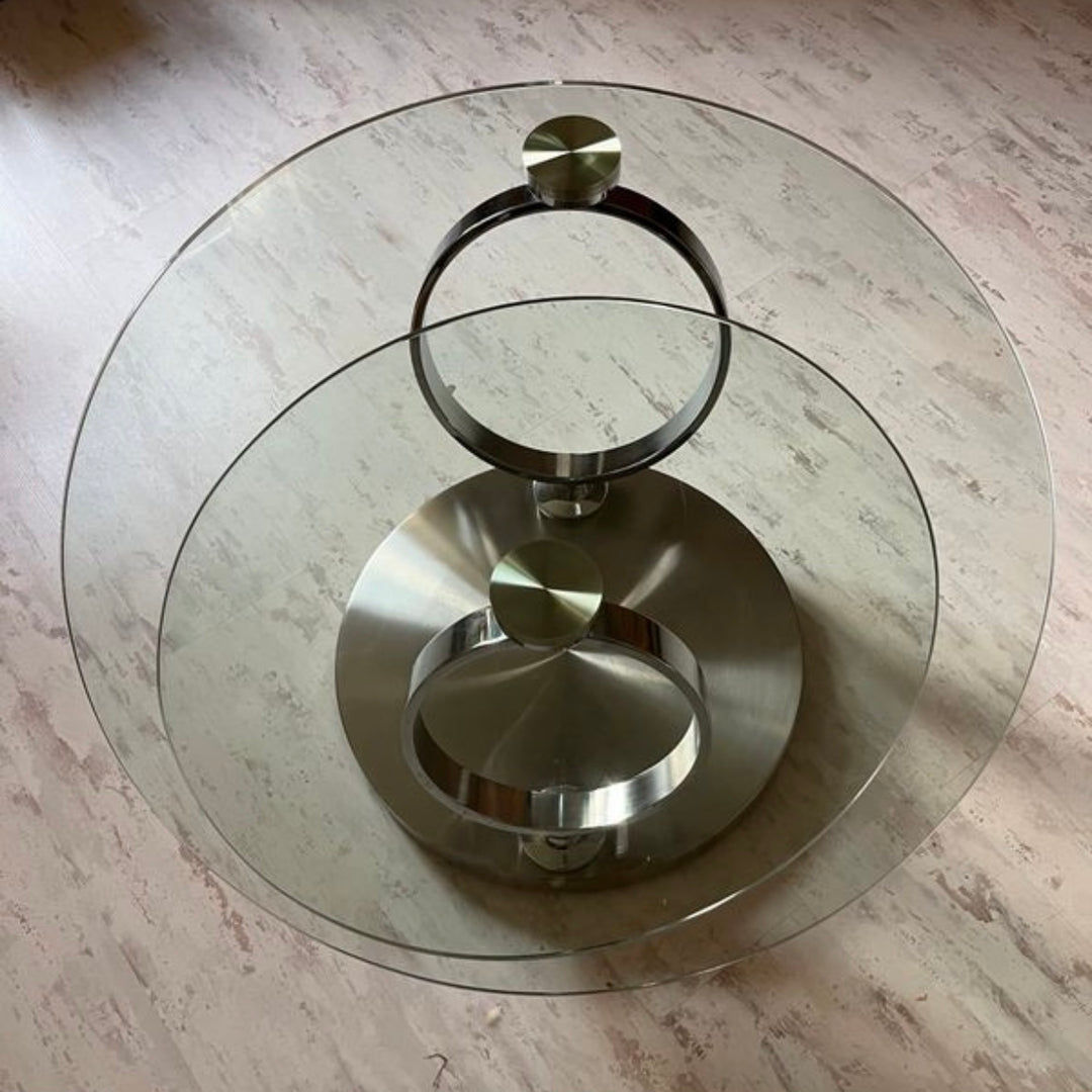 Pivoting glass and stainless steel coffee table