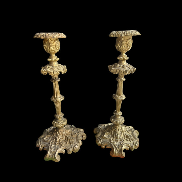 Pair of XIXth century candlesticks in bronze decor of female mascarons and flowers