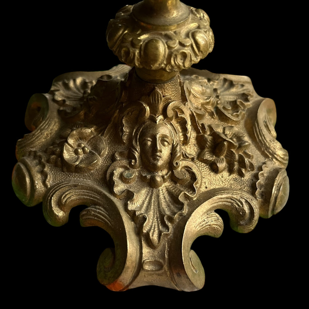 Pair of XIXth century candlesticks in bronze decor of female mascarons and flowers