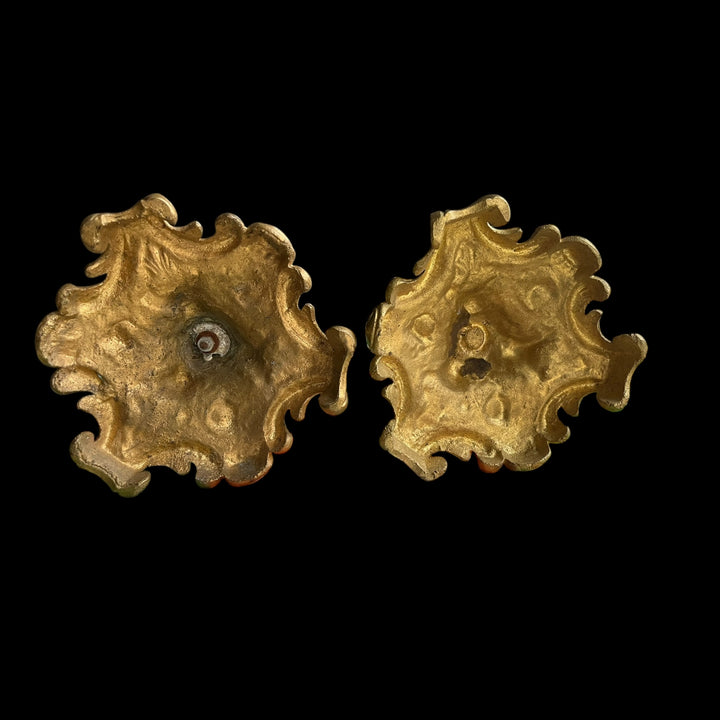 Pair of XIXth century candlesticks in bronze decor of female mascarons and flowers