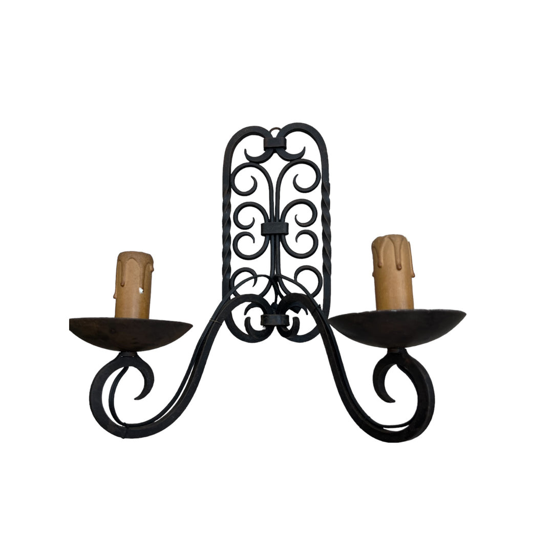 A double wrought iron wall lamp