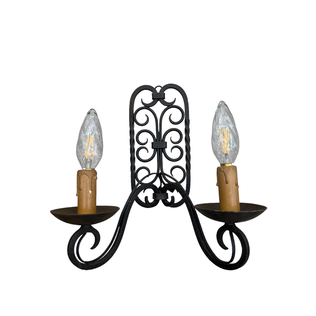 A double wrought iron wall lamp