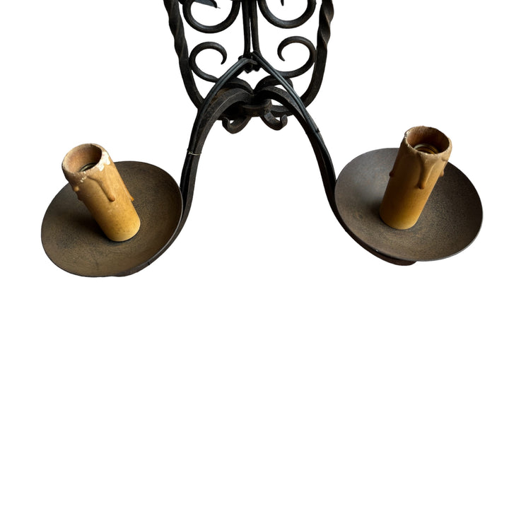 A double wrought iron wall lamp