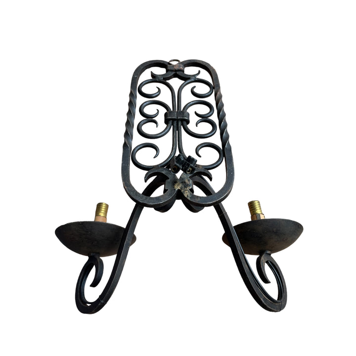 A double wrought iron wall lamp