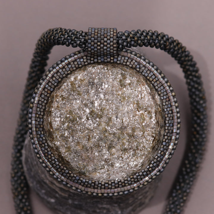 Embroidered necklace with mica schist (mica and garnet)