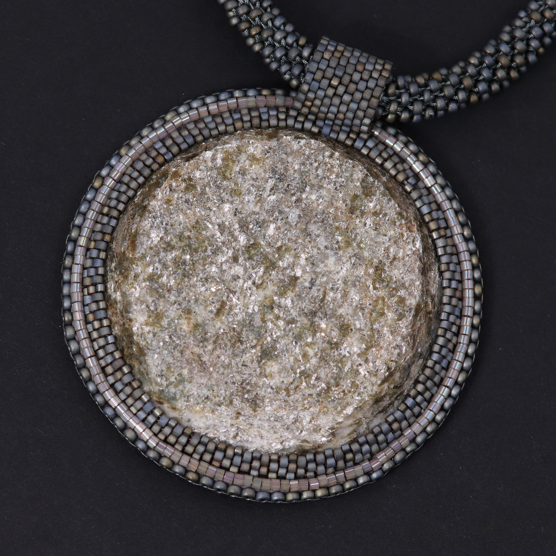 Embroidered necklace with mica schist (mica and garnet)