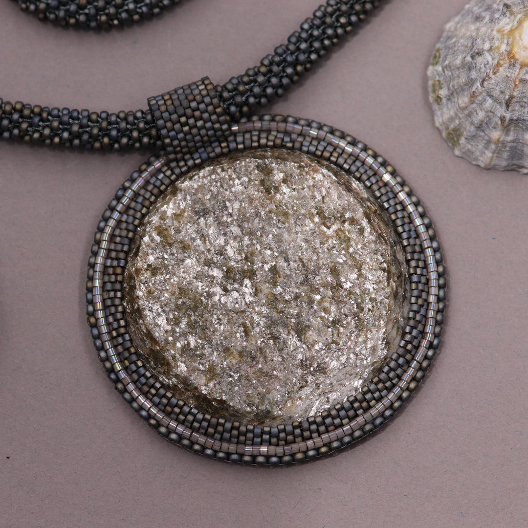 Embroidered necklace with mica schist (mica and garnet)