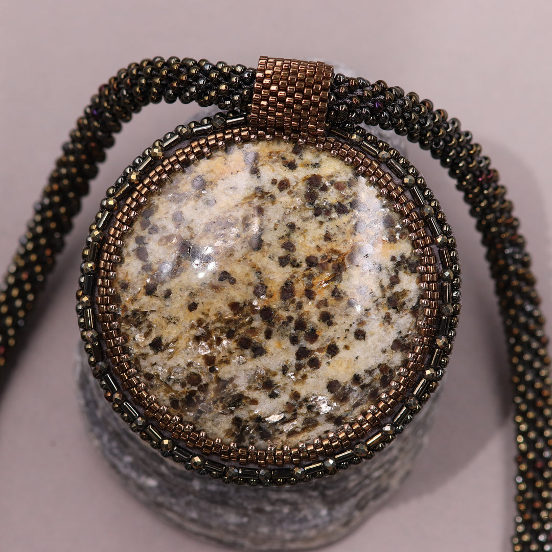 Embroidered necklace with mica schist (mica and garnet)