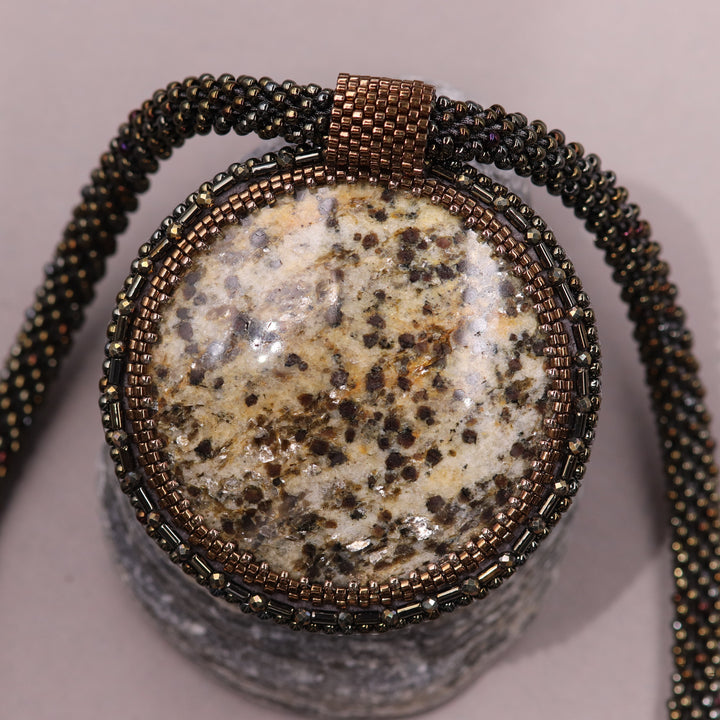 Embroidered necklace with mica schist (mica and garnet)
