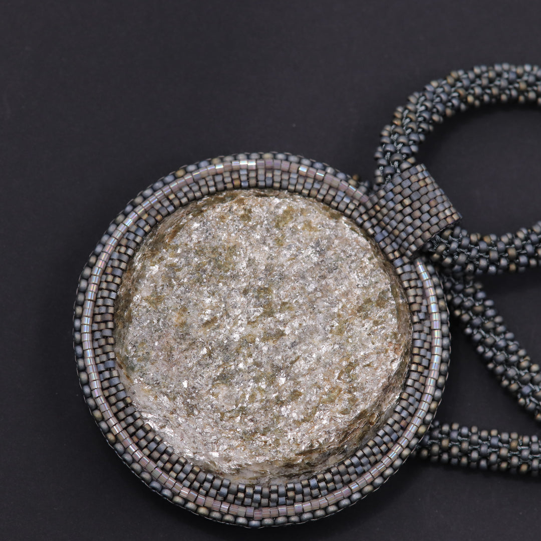 Embroidered necklace with mica schist (mica and garnet)