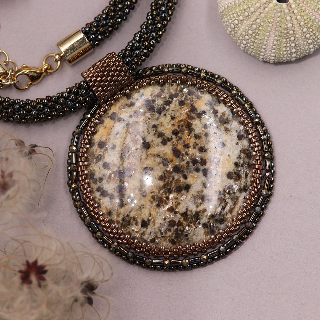 Embroidered necklace with mica schist (mica and garnet)