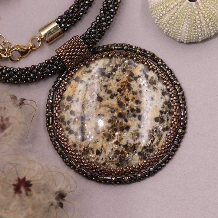 Embroidered necklace with mica schist (mica and garnet)