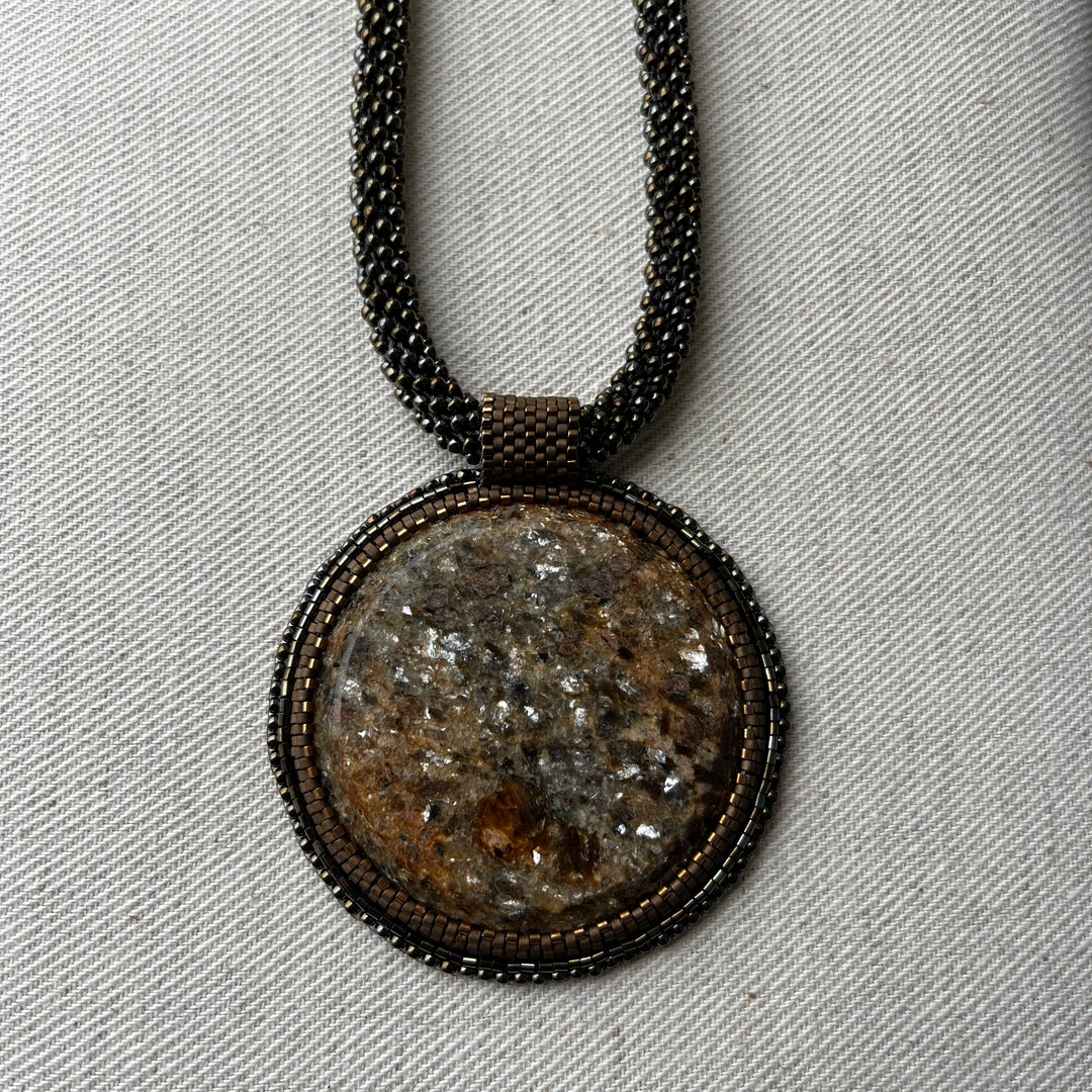 Embroidered necklace with mica schist (mica and garnet)