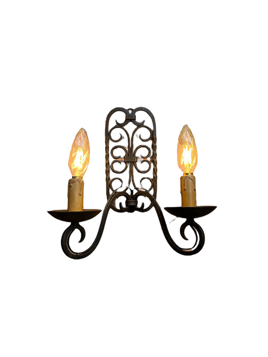 A double wrought iron wall lamp