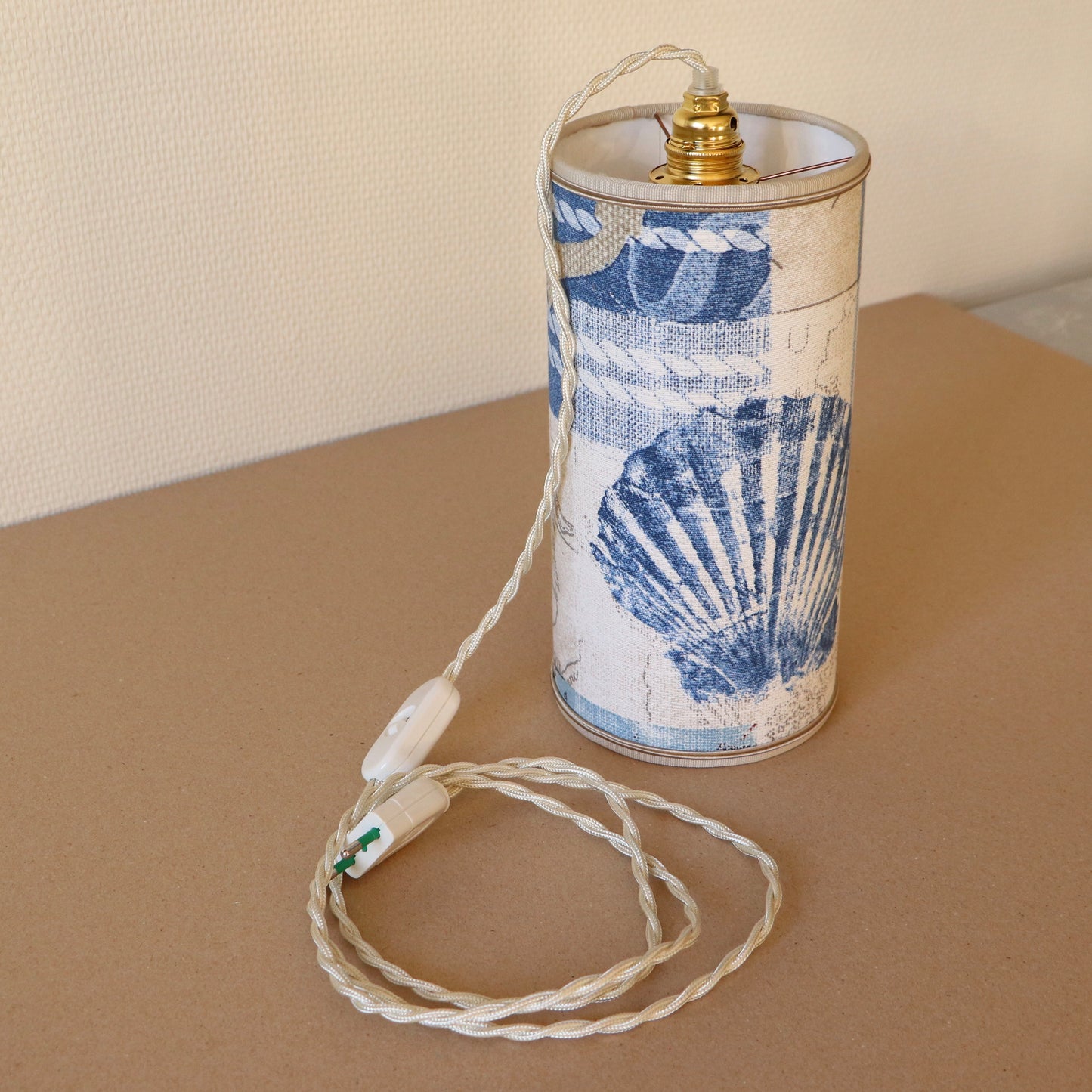 Portable lamp with a laminated lampshade in COQUILLE fabric