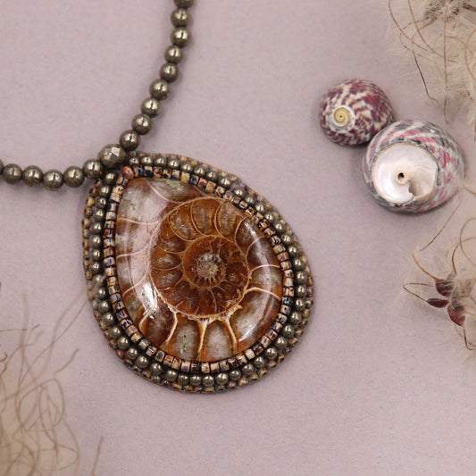 Embroidered necklace with ammonite and pyrite