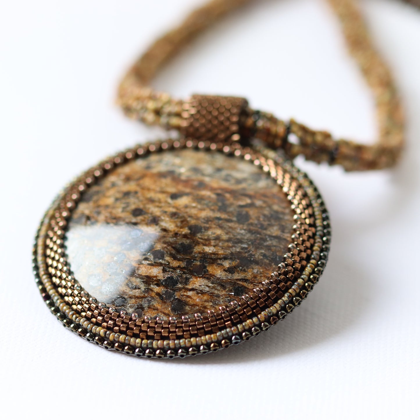 Embroidered necklace with mica schist (mica and garnet) 