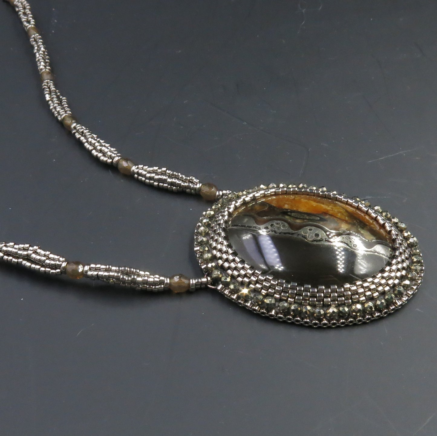 Necklace with pyritized ammonite and yellow calcite
