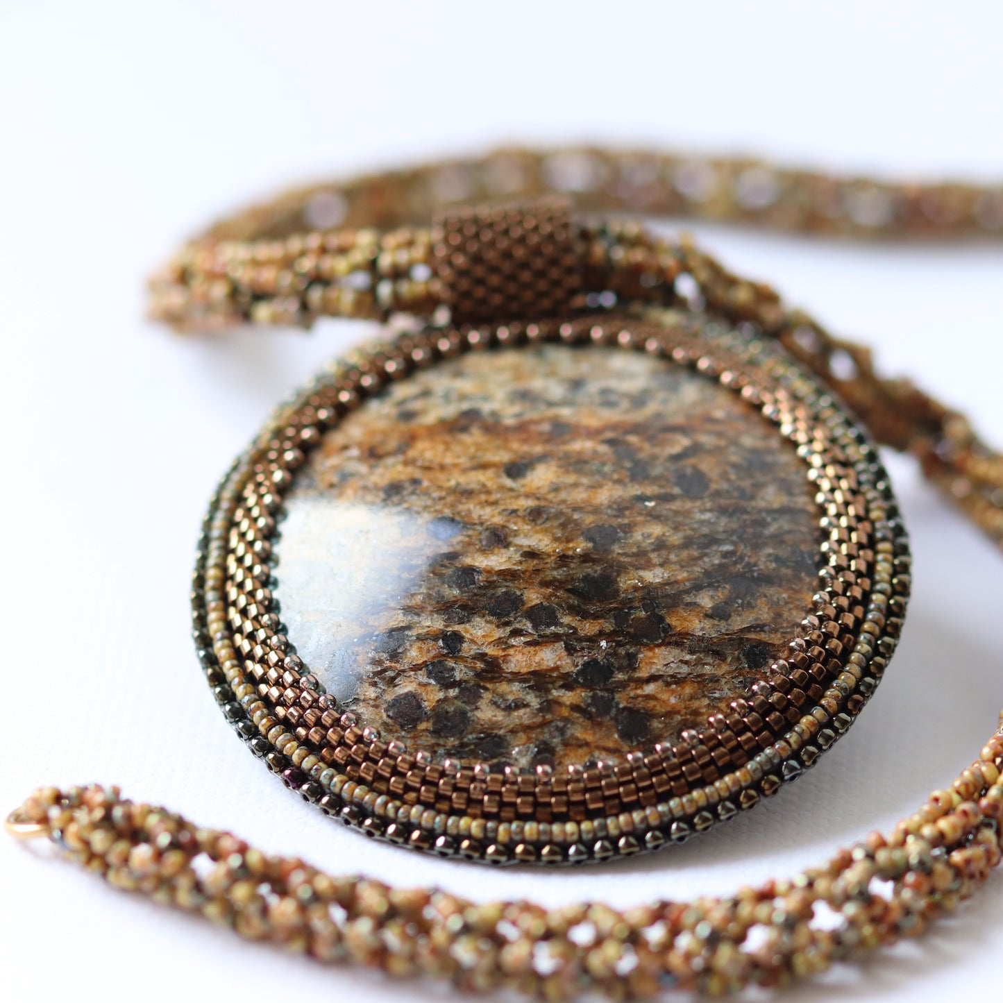 Embroidered necklace with mica schist (mica and garnet) 