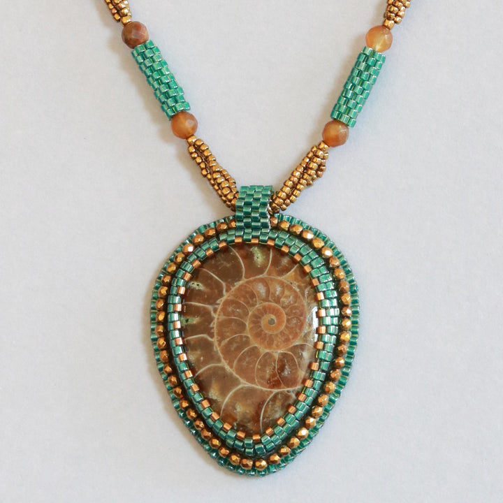 Embroidered necklace with ammonite and pyrite
