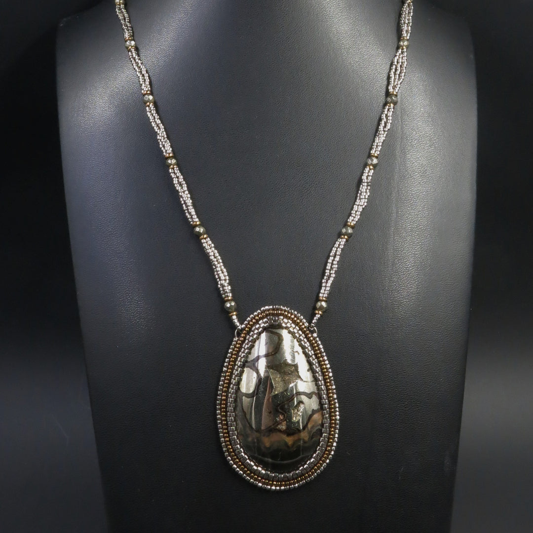Necklace with pyritized ammonite, yellow calcite