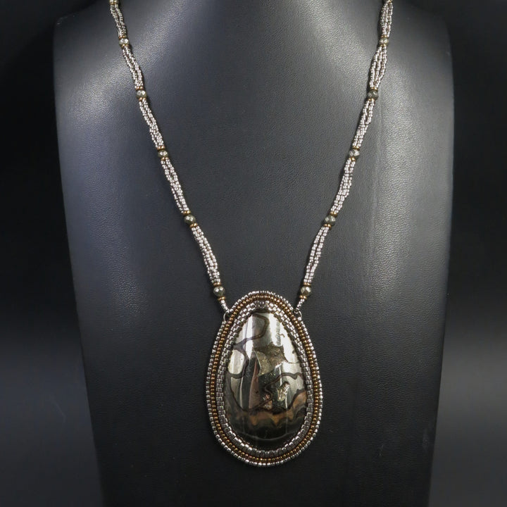 Necklace with pyritized ammonite, yellow calcite