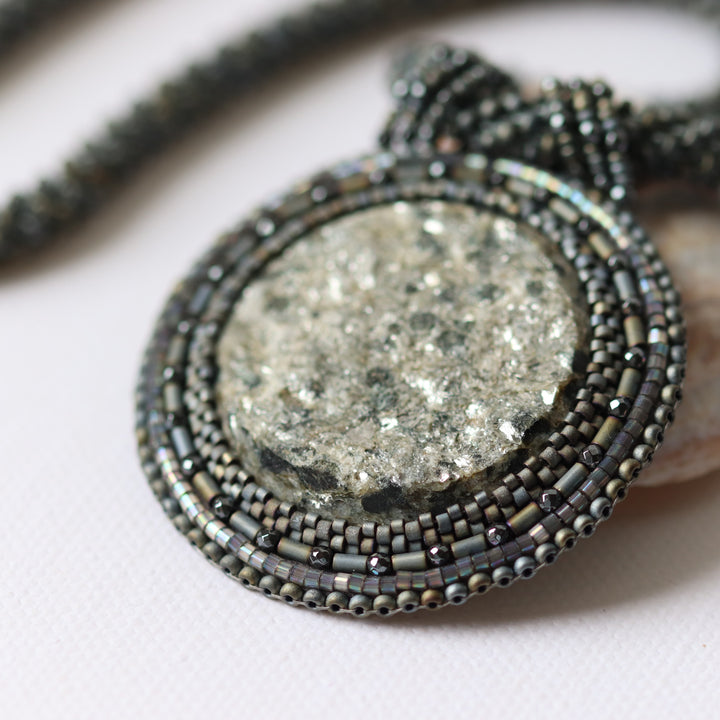 Embroidered necklace with mica schist (contains mica and garnet)