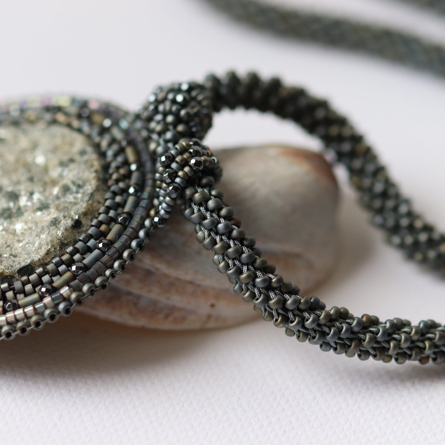 Embroidered necklace with mica schist (contains mica and garnet)