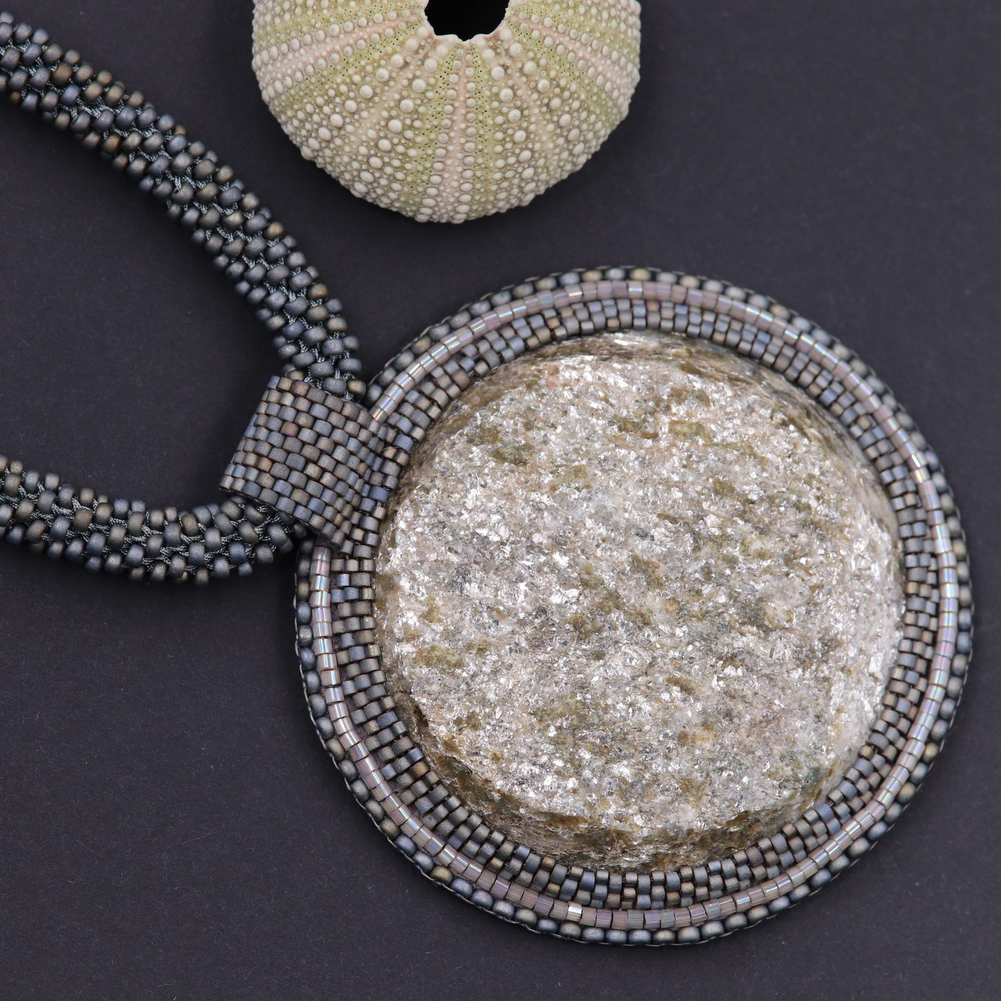 Embroidered necklace with mica schist (mica and garnet)