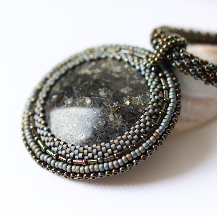 Embroidered necklace with mica schist (mica and garnet)